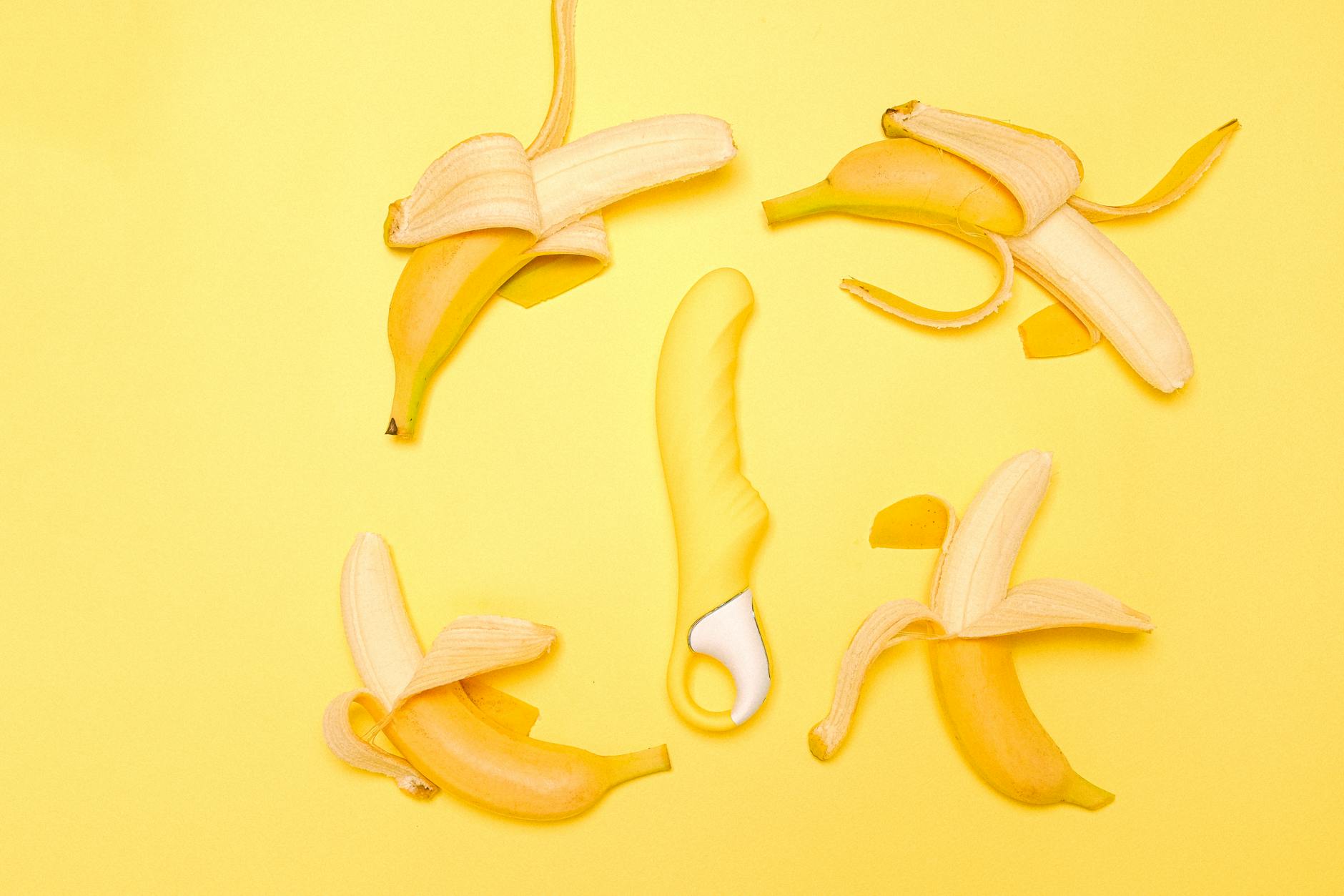 A bright yellow lemon vibrator on a sunny yellow background, symbolizing fresh pleasure and renewed sensation