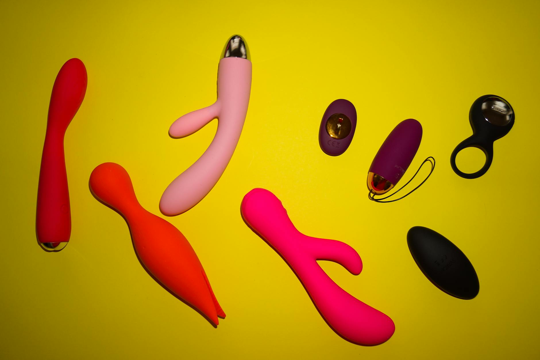 Colorful clitoral vibrators and intimate wellness toys arranged on a bright surface